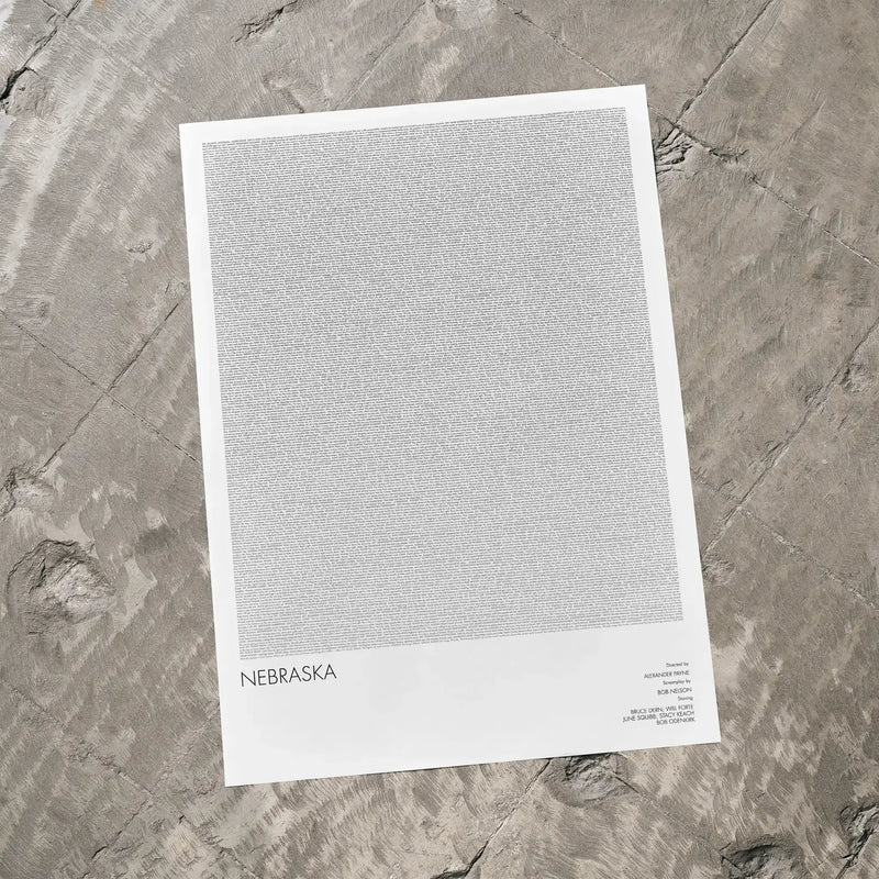 A Nebraska movie script poster laid flat on a textured floor surface.
