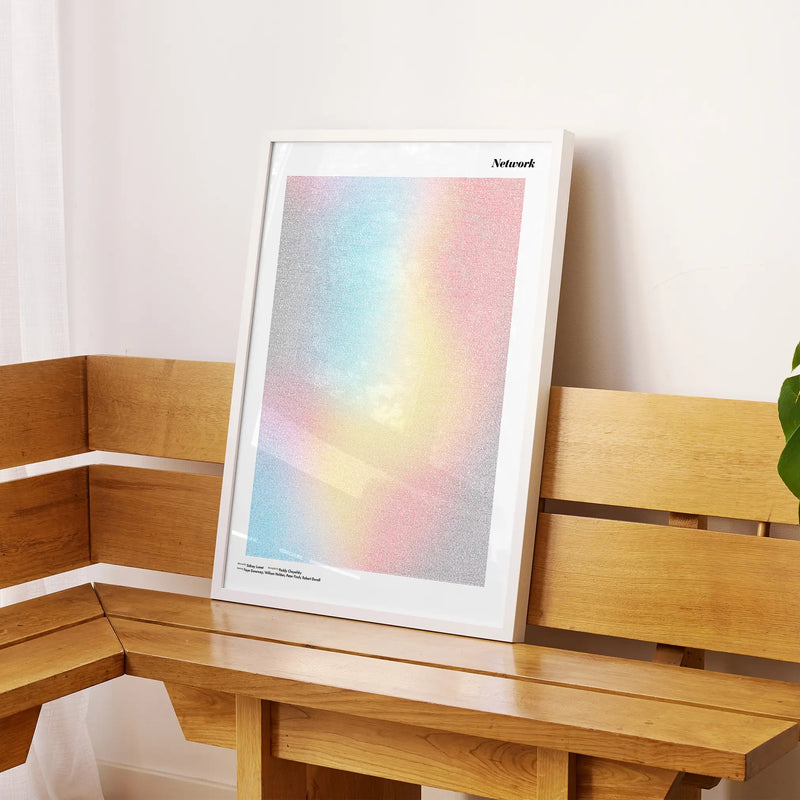 A framed Network movie script poster displayed on a sideboard in a contemporary space.