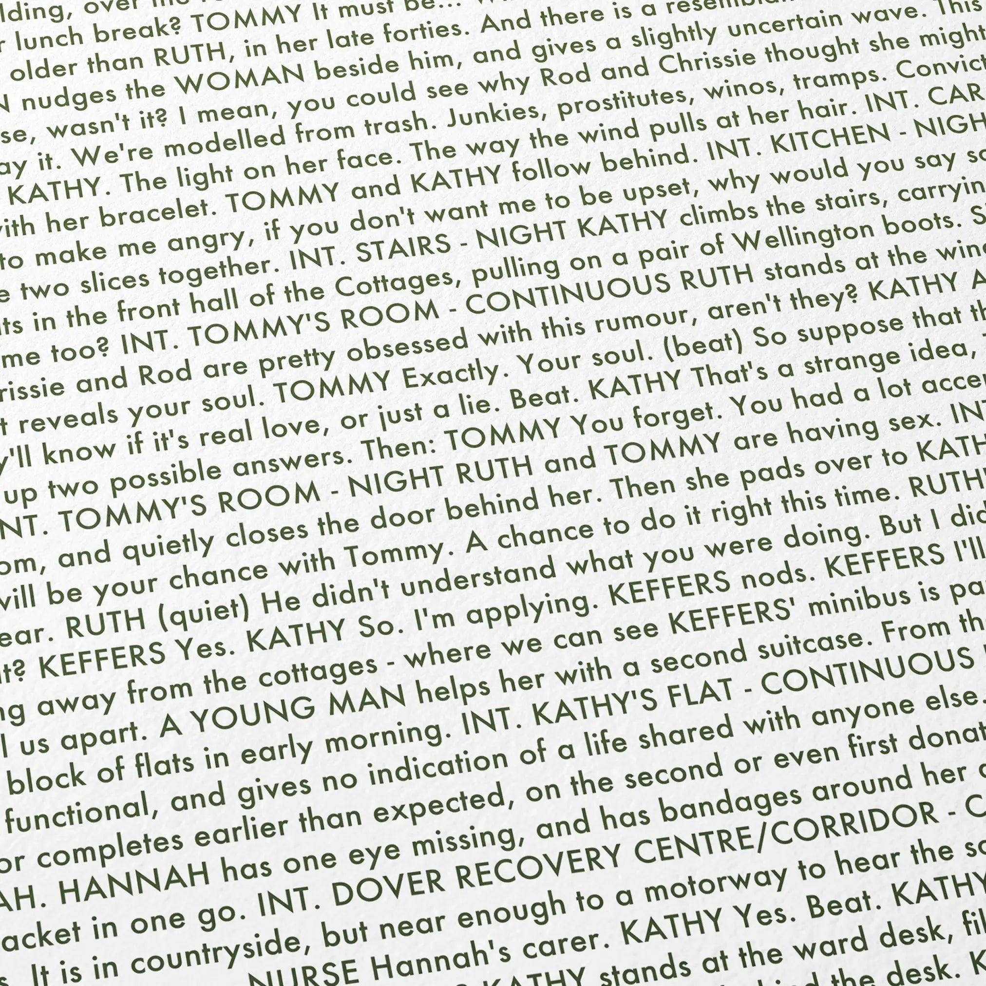Close-up detail of the Never Let Me Go movie script poster showing dense typographic text.