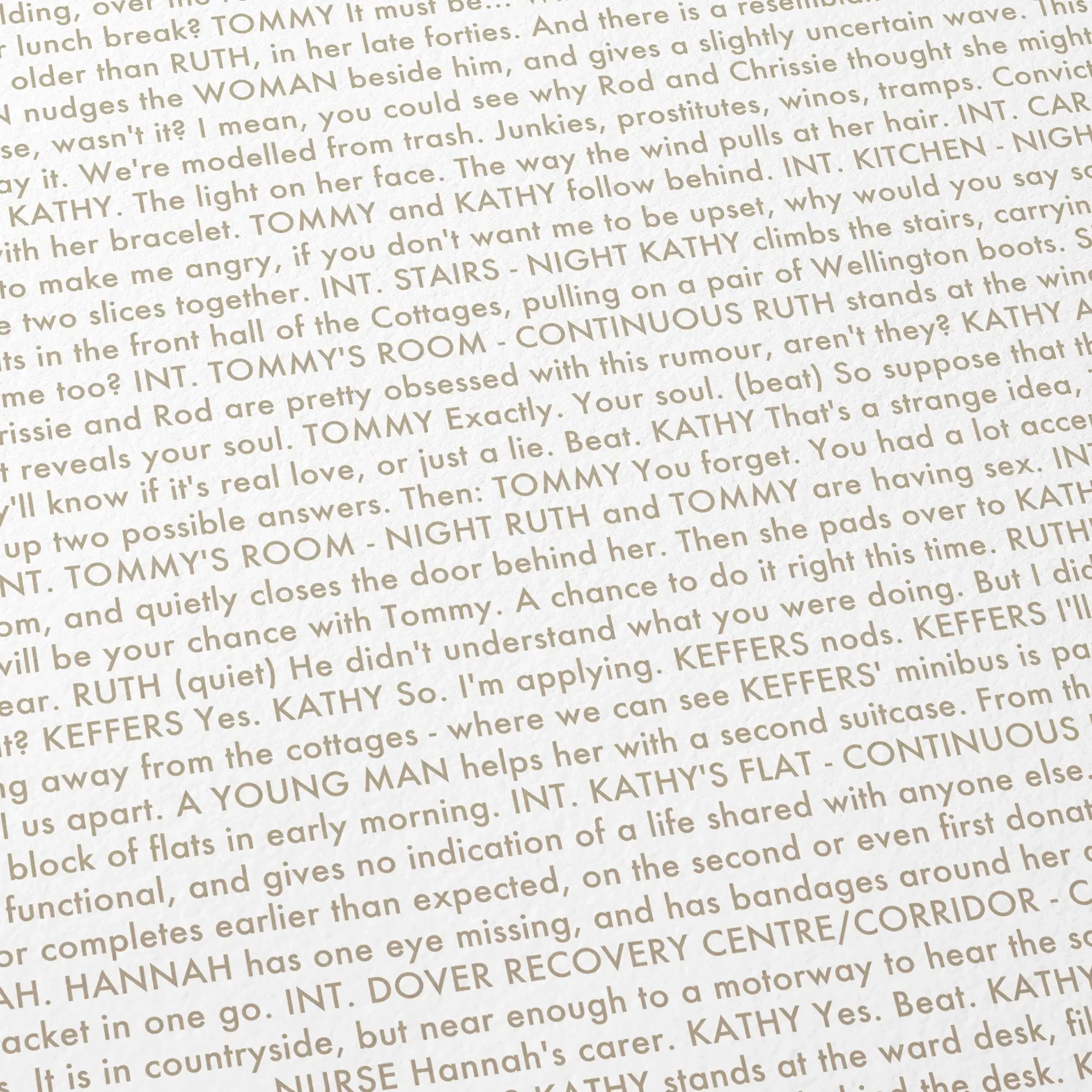 Close-up detail of the Never Let Me Go movie script poster showing dense typographic text.