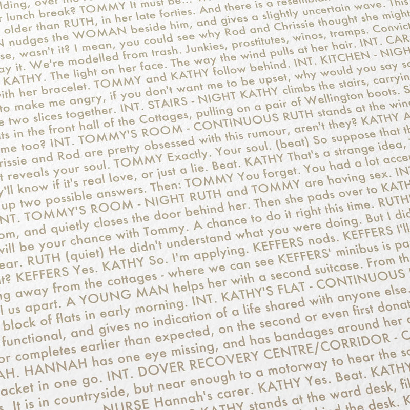 Close-up detail of the Never Let Me Go movie script poster showing dense typographic text.