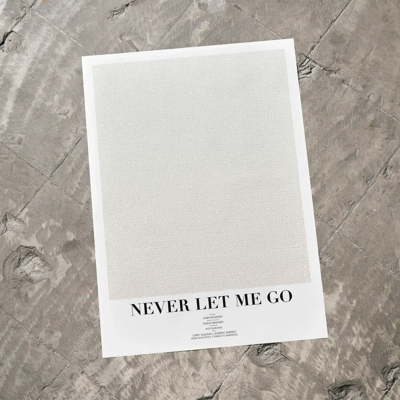 A Never Let Me Go movie script poster laid flat on a textured floor surface.