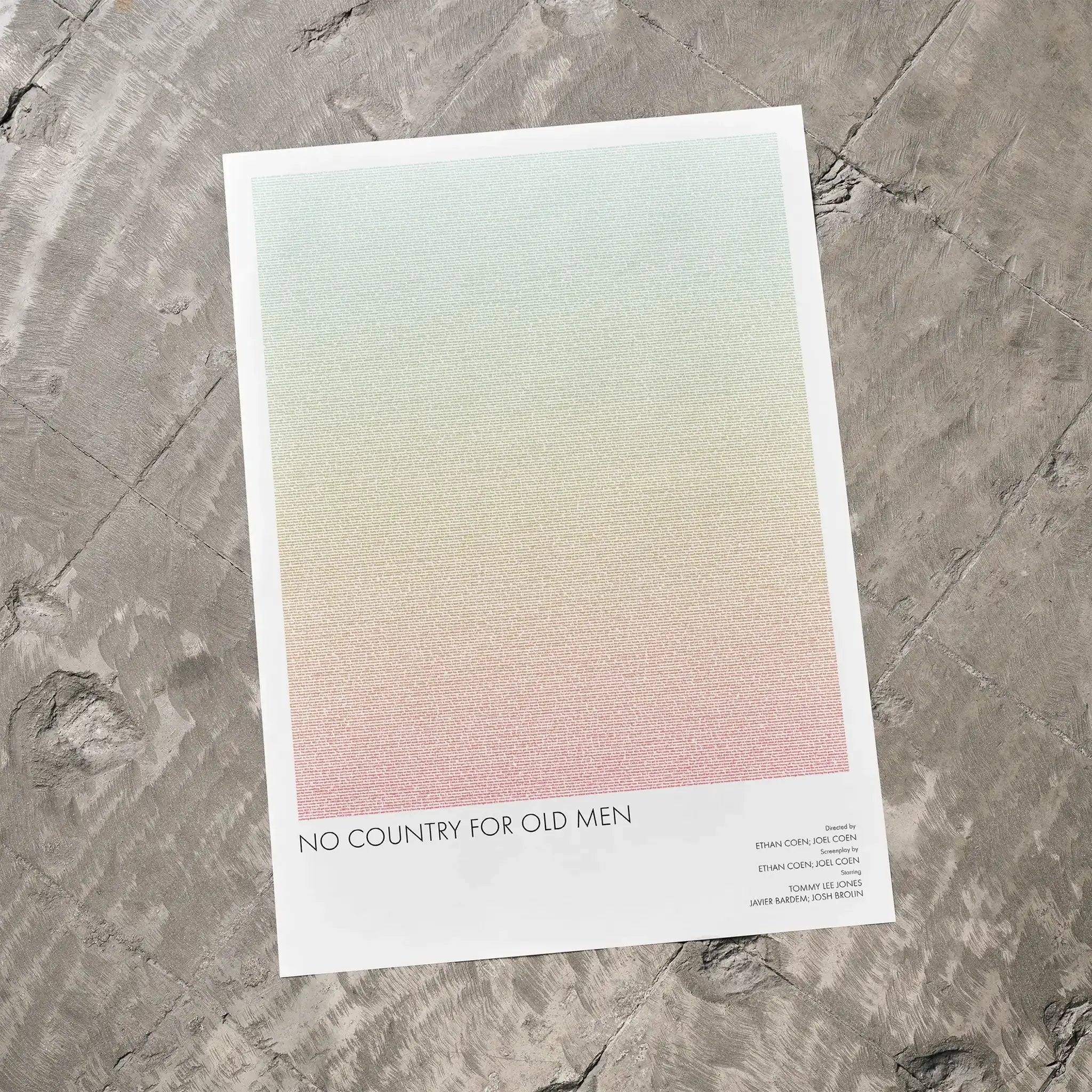 A No Country for Old Men movie script poster laid flat on a textured floor surface.