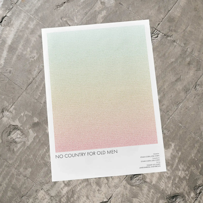A No Country for Old Men movie script poster laid flat on a textured floor surface.
