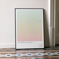 A framed No Country for Old Men movie script poster leaning against a wall in a minimalist interior.