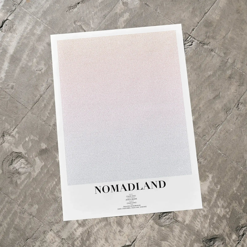 A Nomadland movie script poster laid flat on a textured floor surface.