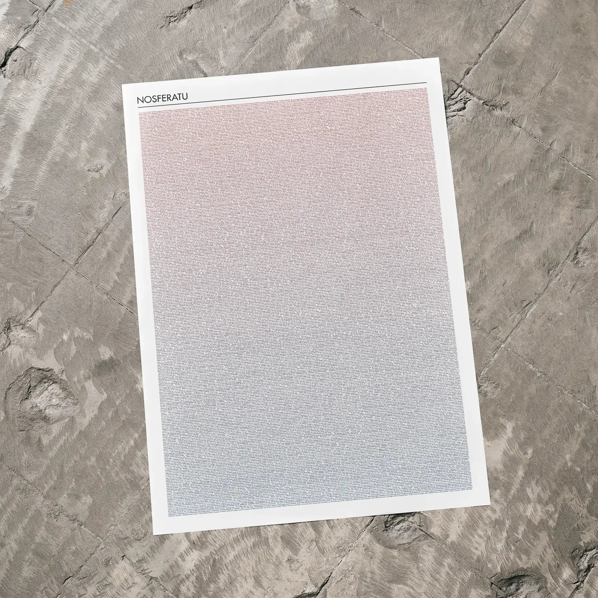 A Nosferatu movie script poster laid flat on a textured floor surface.