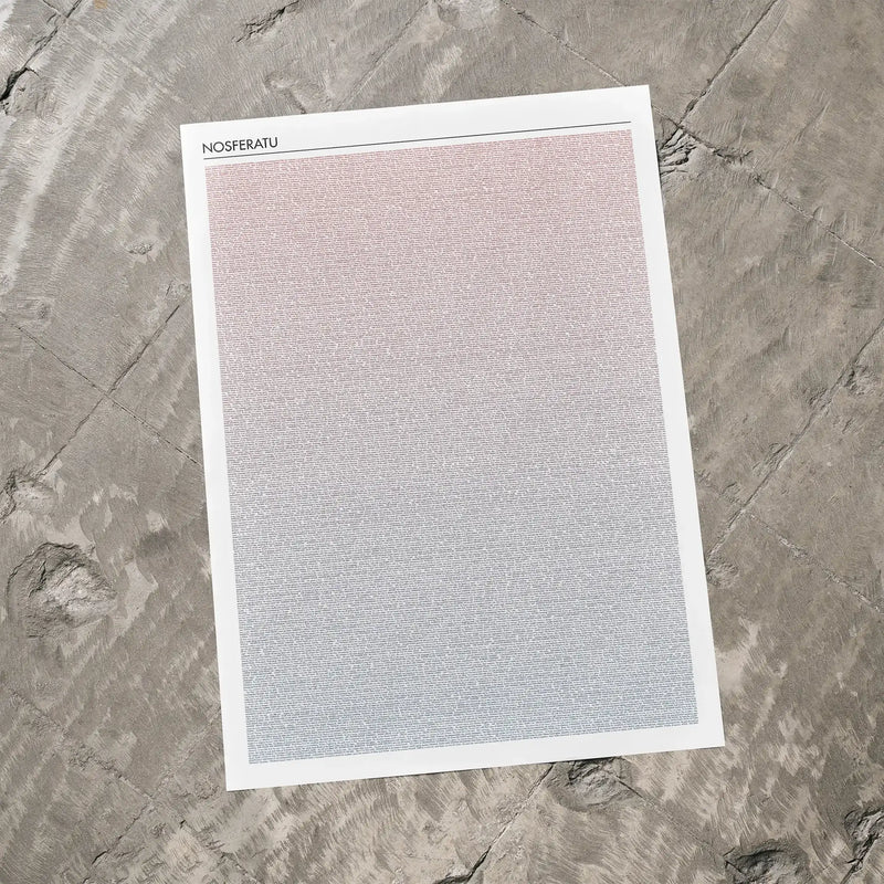 A Nosferatu movie script poster laid flat on a textured floor surface.