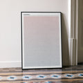A framed Nosferatu movie script poster leaning against a wall in a minimalist interior.