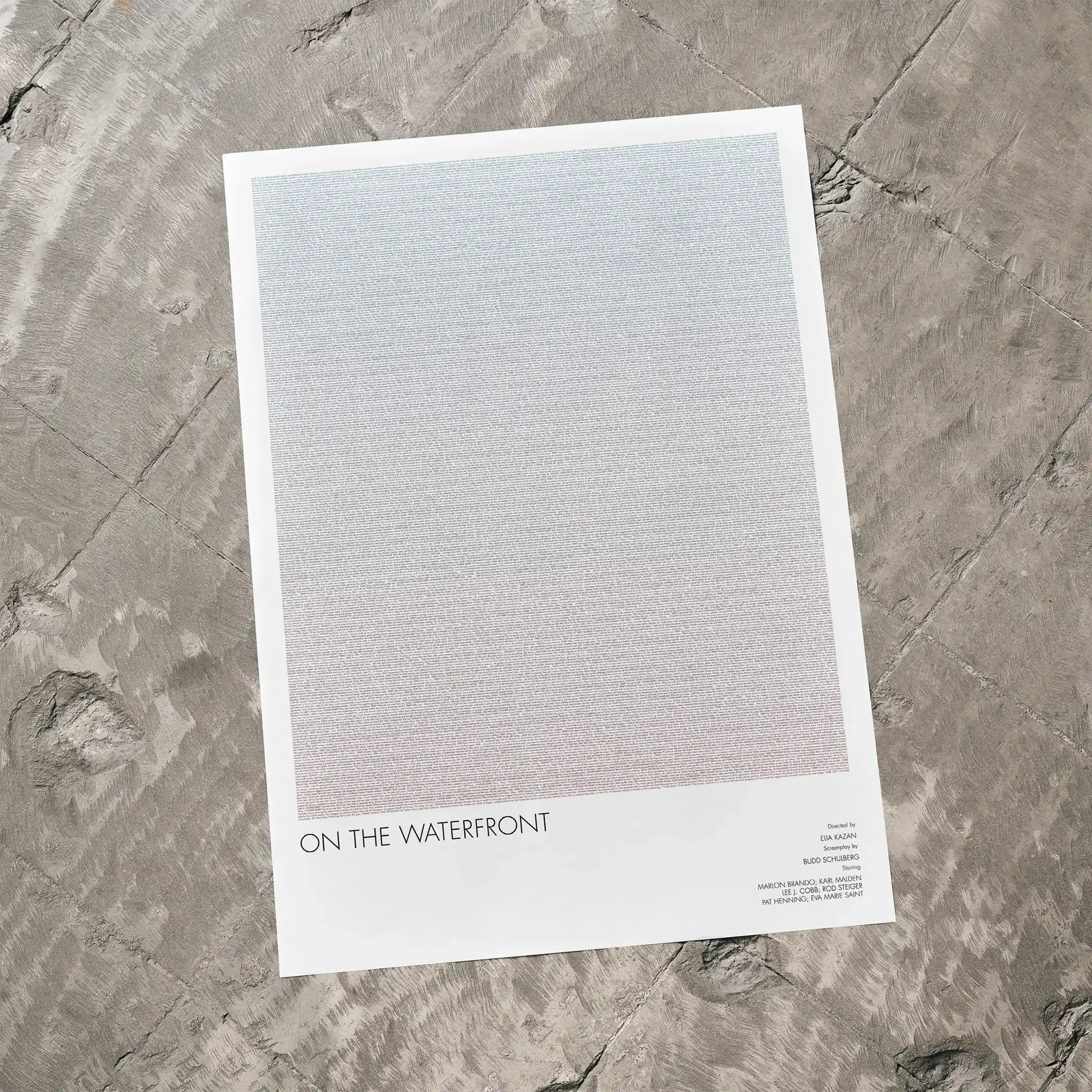 A On the Waterfront movie script poster laid flat on a textured floor surface.