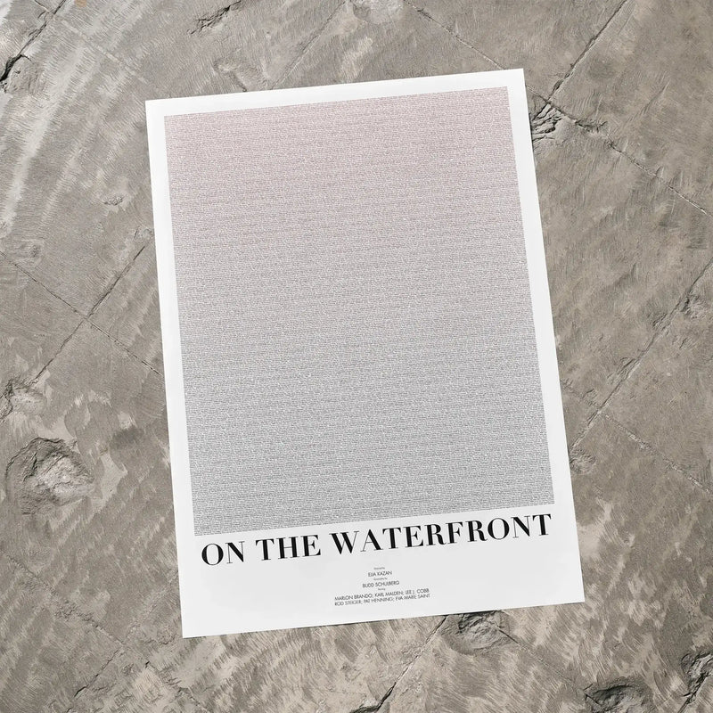 A On the Waterfront movie script poster laid flat on a textured floor surface.