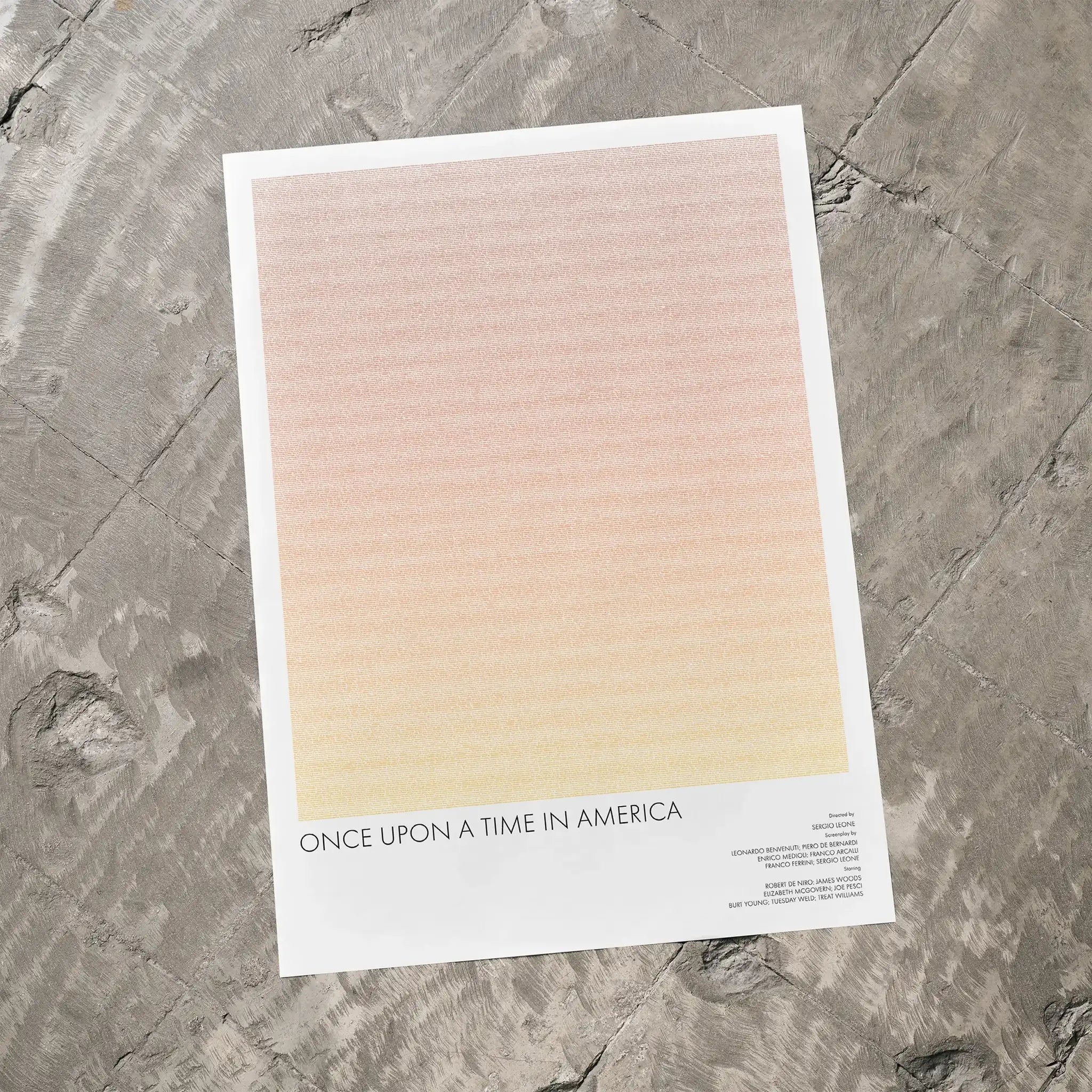 A Once Upon a Time in America movie script poster laid flat on a textured floor surface.