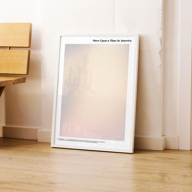 A framed Once Upon a Time in America movie script poster leaning against a wall in a modern interior.