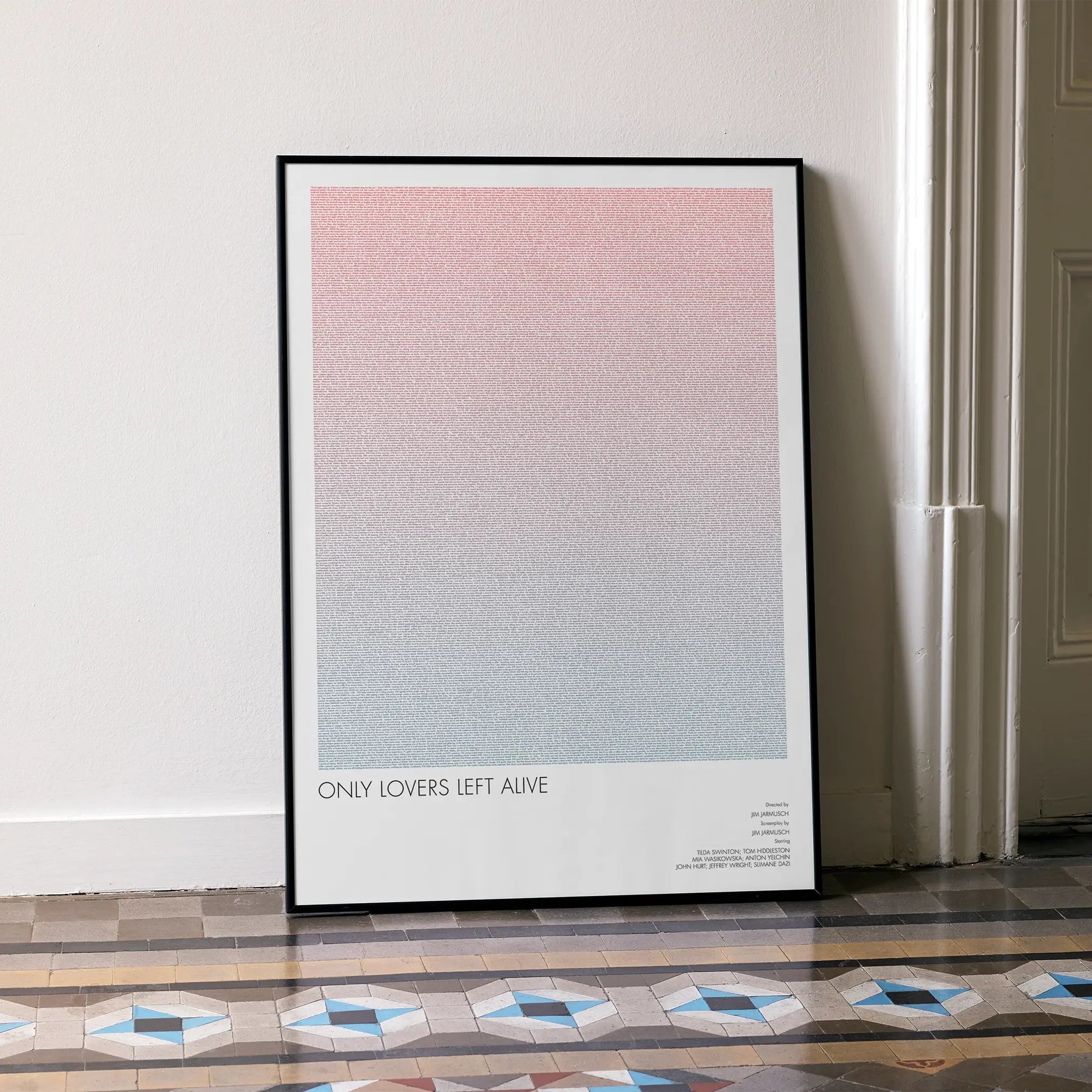 A framed Only Lovers Left Alive movie script poster leaning against a wall in a minimalist interior.