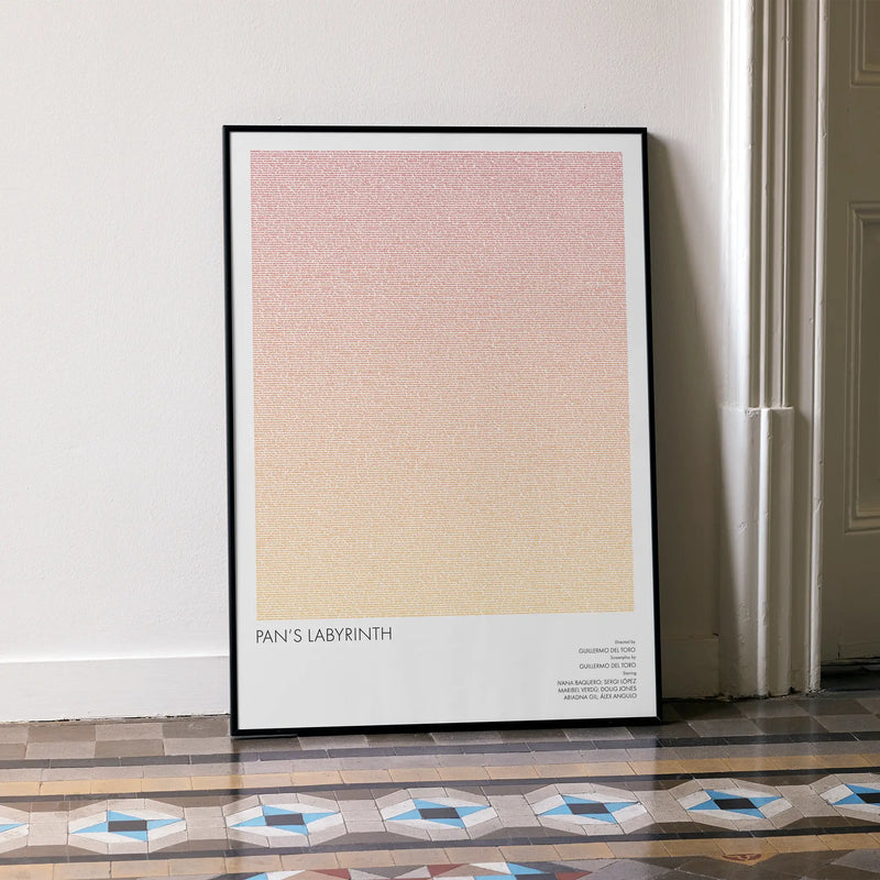 A framed Pan's Labyrinth movie script poster leaning against a wall in a minimalist interior.