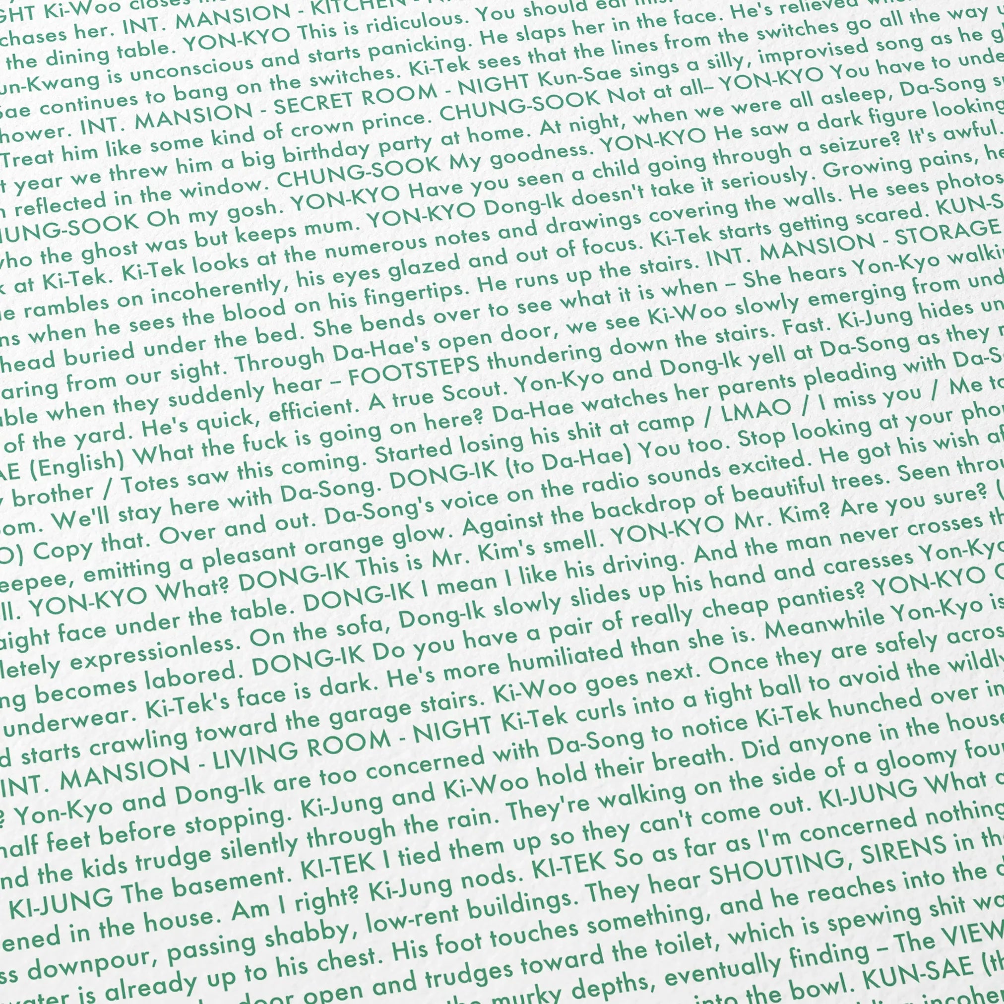 Close-up detail of the Parasite movie script poster showing dense typographic text.