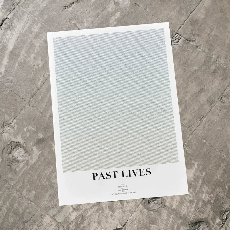 A Past Lives movie script poster laid flat on a textured floor surface.