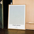 A framed Past Lives movie script poster displayed in a contemporary interior setting.