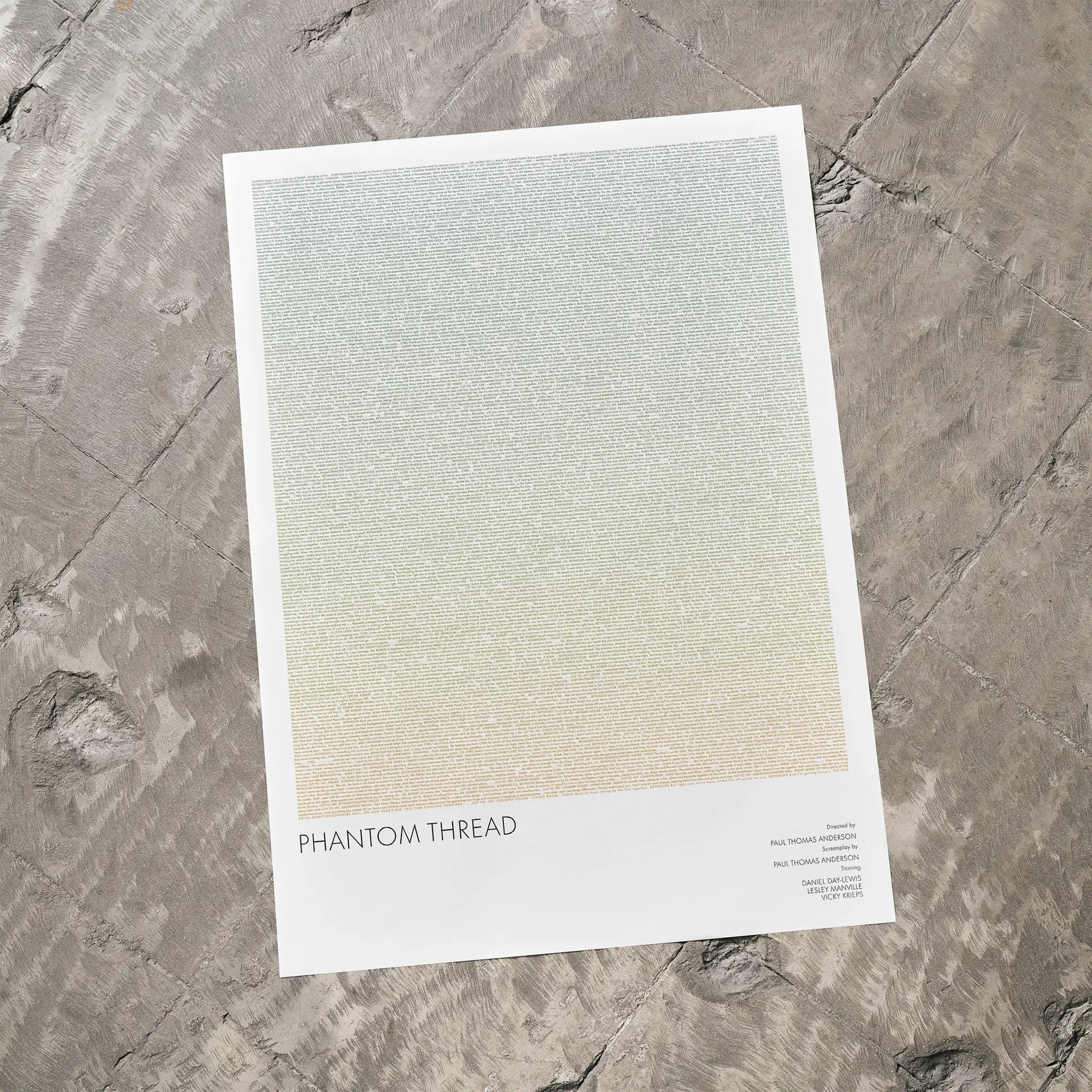 A Phantom Thread movie script poster laid flat on a textured floor surface.