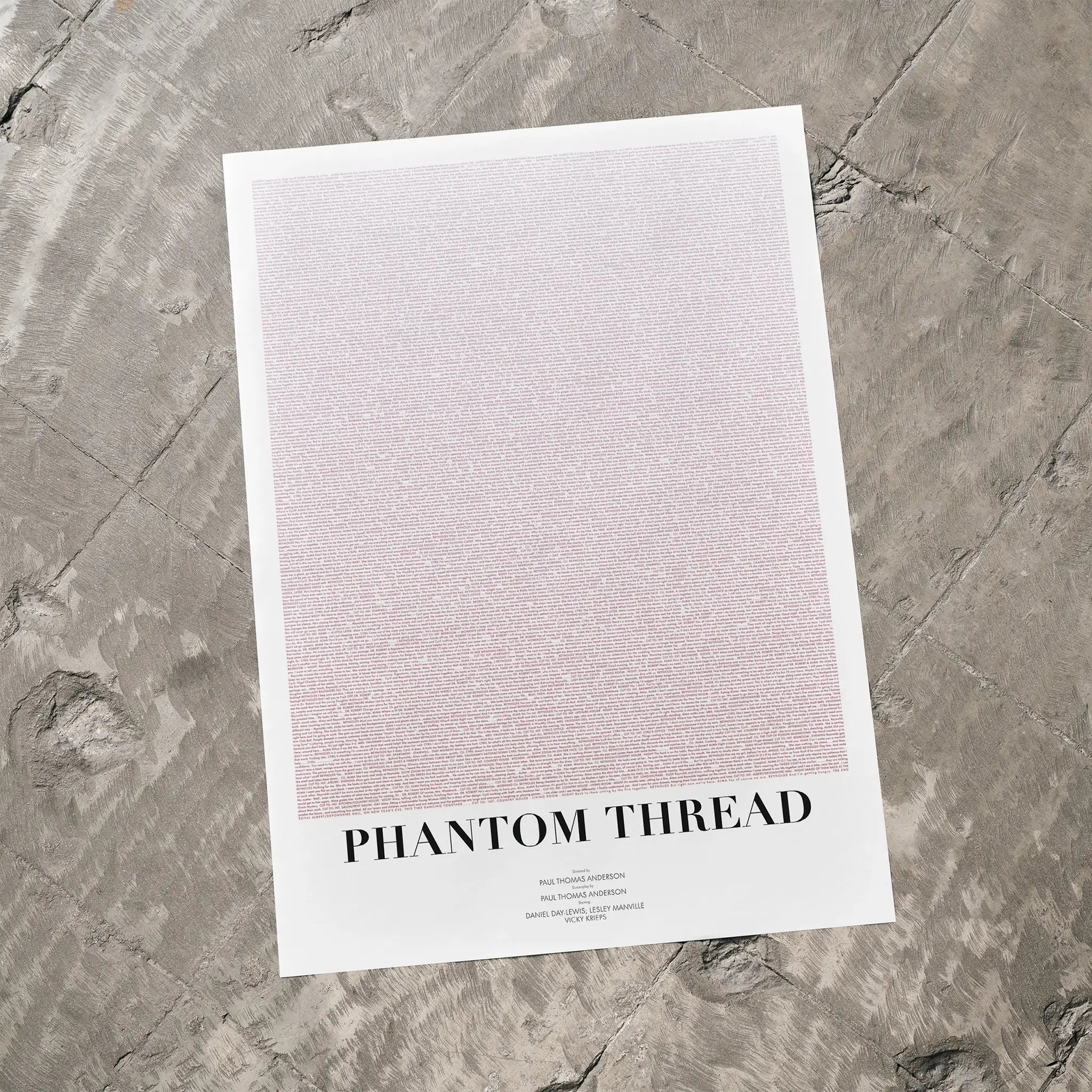 A Phantom Thread movie script poster laid flat on a textured floor surface.