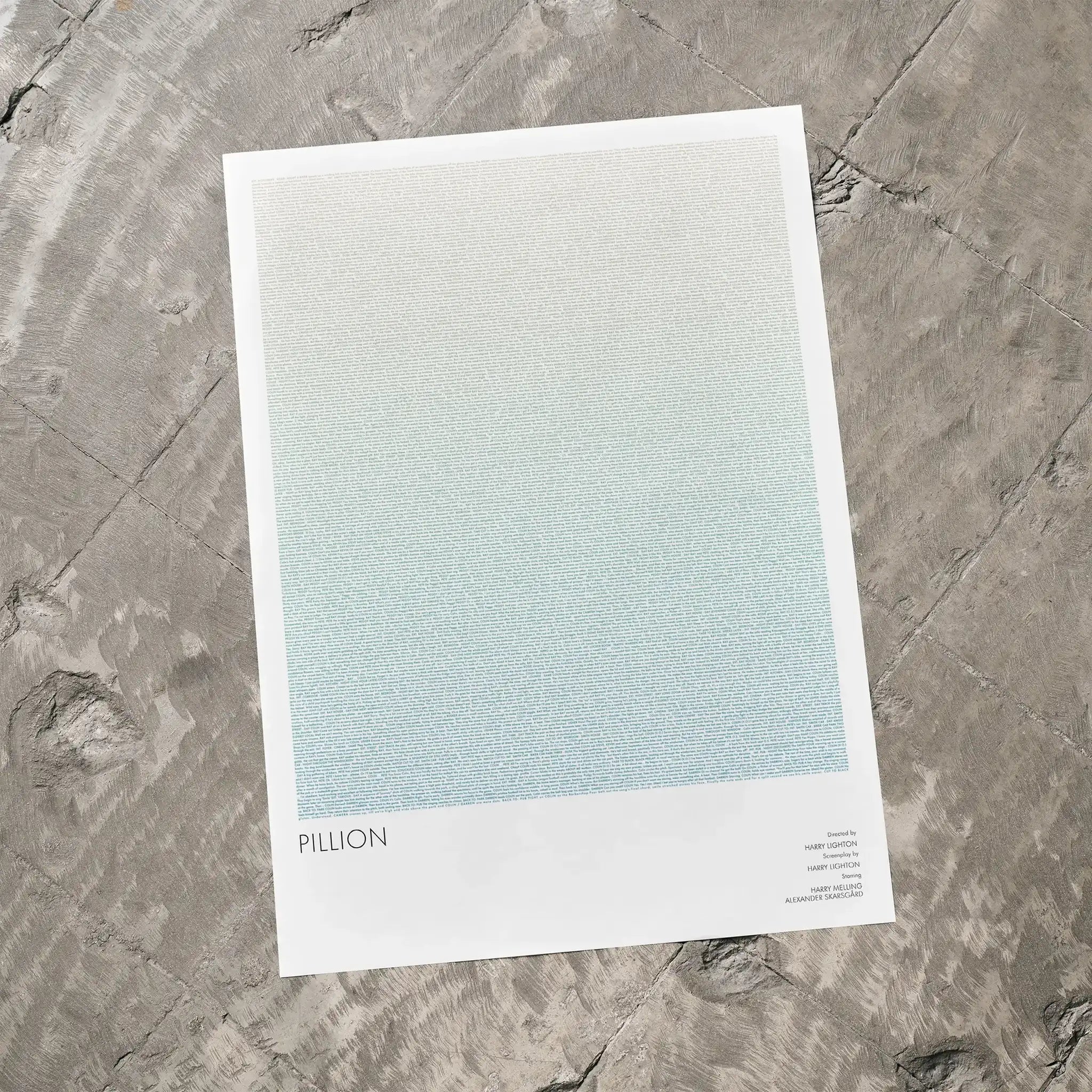 Pillion movie poster lays on a grey floor