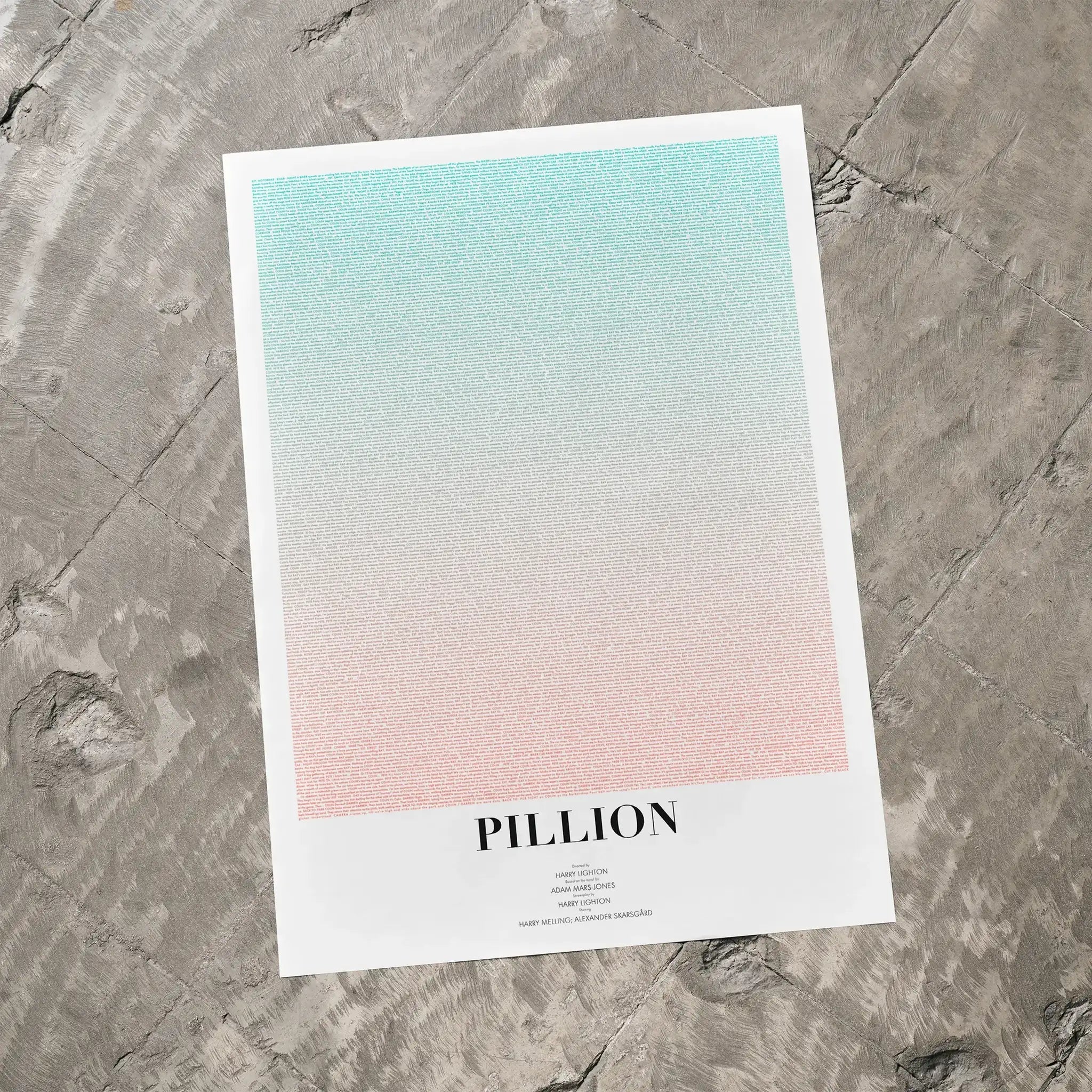 Pillion movie poster with gradient lays ona concrete floor.

