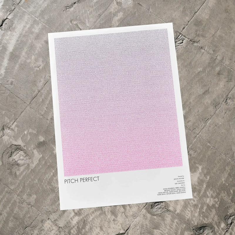 A Pitch Perfect movie script poster laid flat on a textured floor surface.