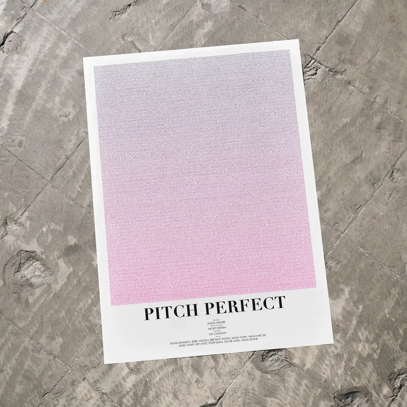 A Pitch Perfect movie script poster laid flat on a textured floor surface.