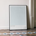 A framed Poor Things movie script poster leaning against a wall in a minimalist interior.