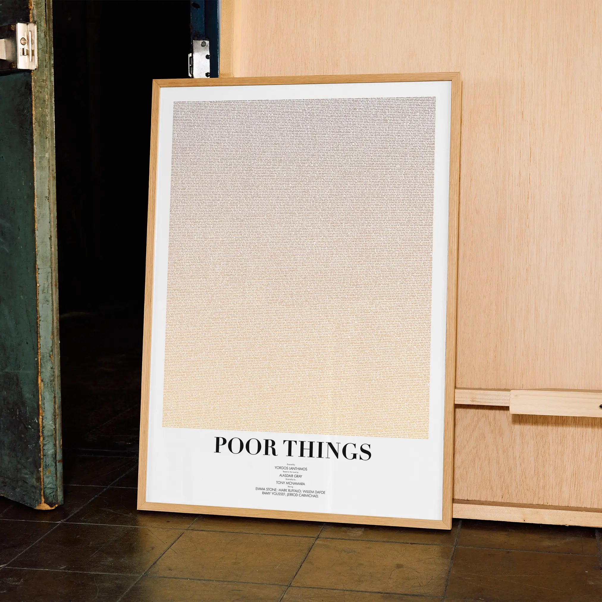 A framed Poor Things movie script poster displayed in a contemporary interior setting.