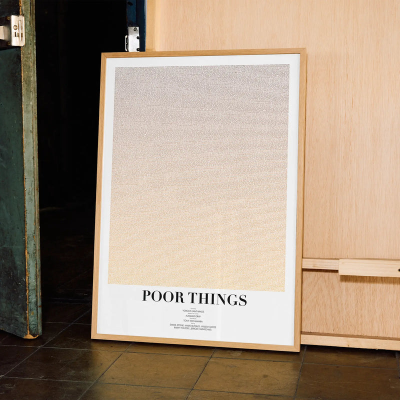 A framed Poor Things movie script poster displayed in a contemporary interior setting.