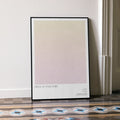 A framed Prick Up Your Ears movie script poster leaning against a wall in a minimalist interior.