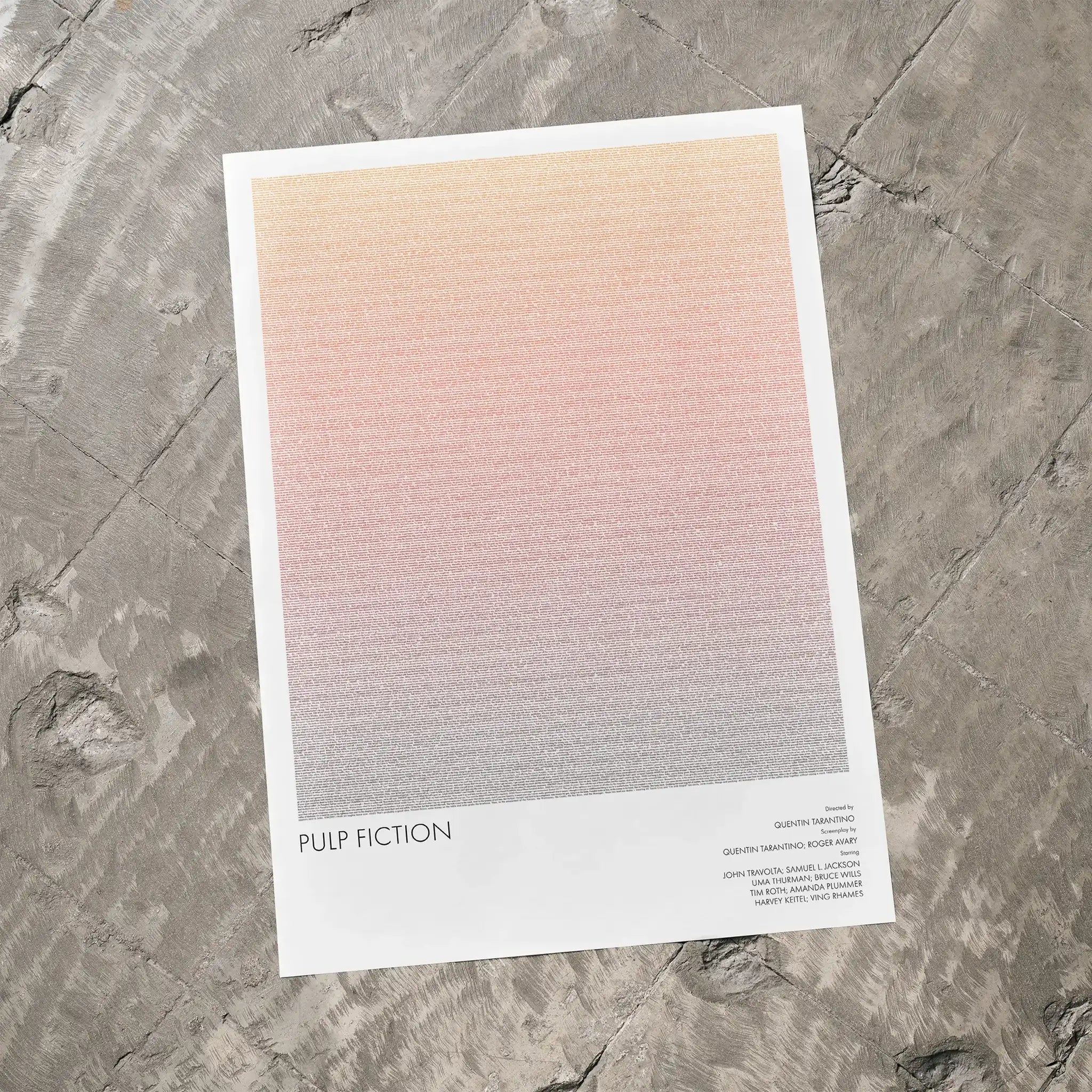 A Pulp Fiction movie script poster laid flat on a textured floor surface.