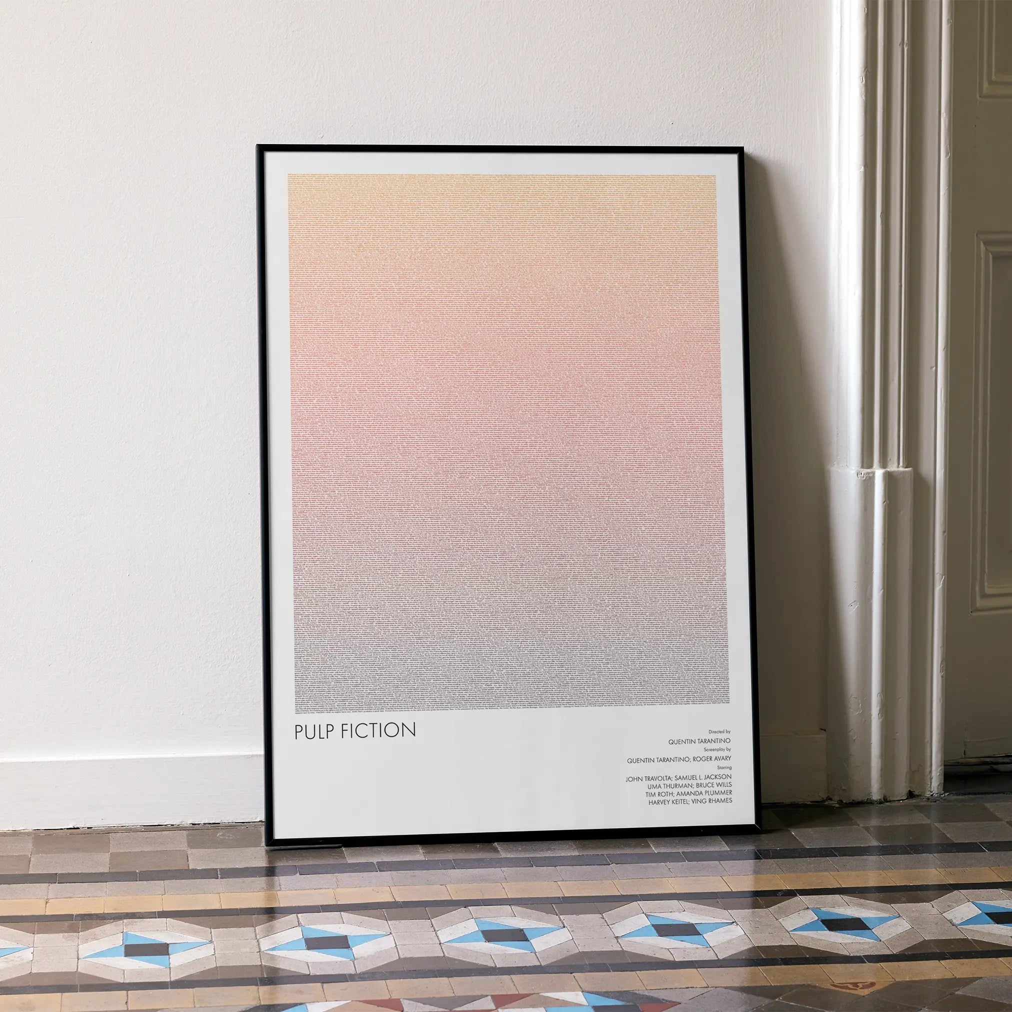 A framed Pulp Fiction movie script poster leaning against a wall in a minimalist interior.