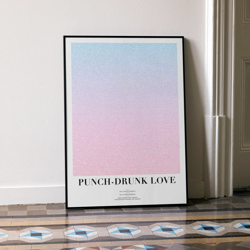 A framed Punch-Drunk Love movie script poster leaning against a wall in a minimalist interior.