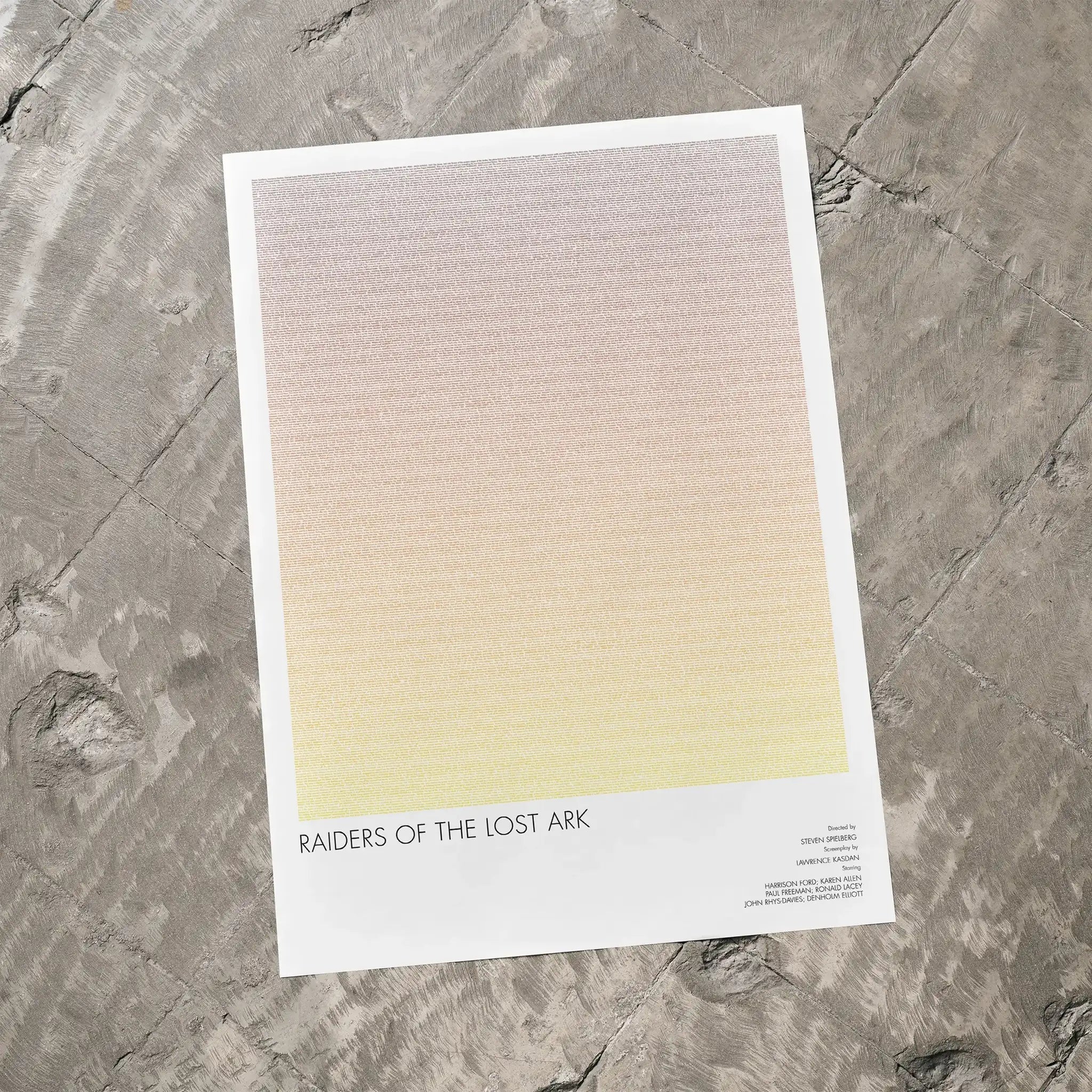 A Raiders of the Lost Ark movie script poster laid flat on a textured floor surface.