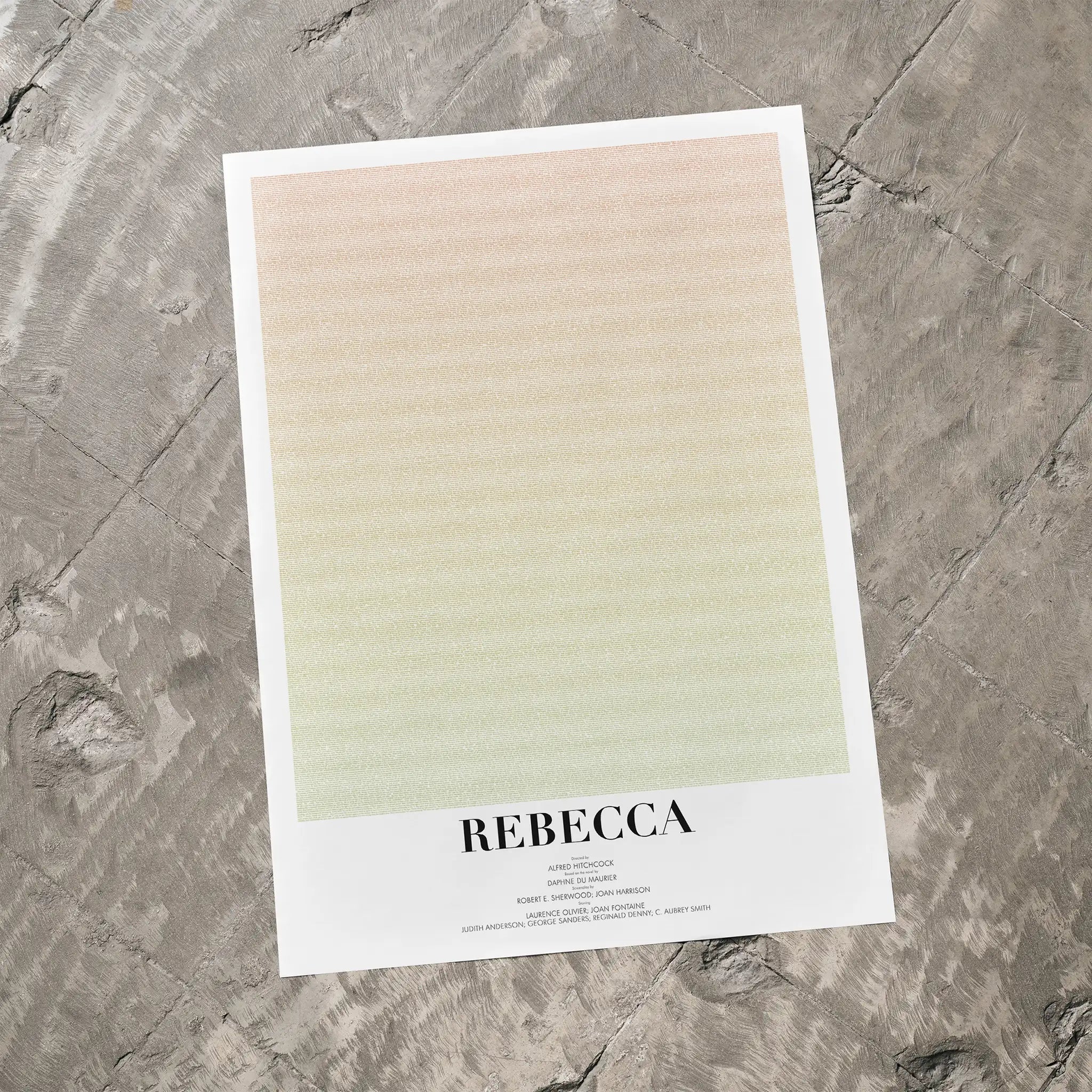 A poster for Hitchcock's "Rebecca" on a grey floor