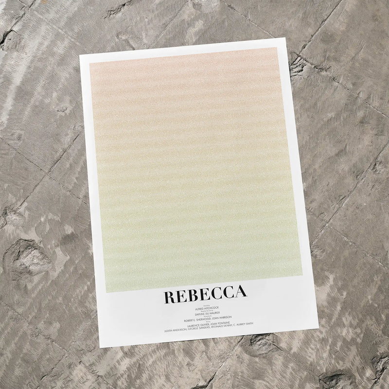 A poster for Hitchcock's "Rebecca" on a grey floor