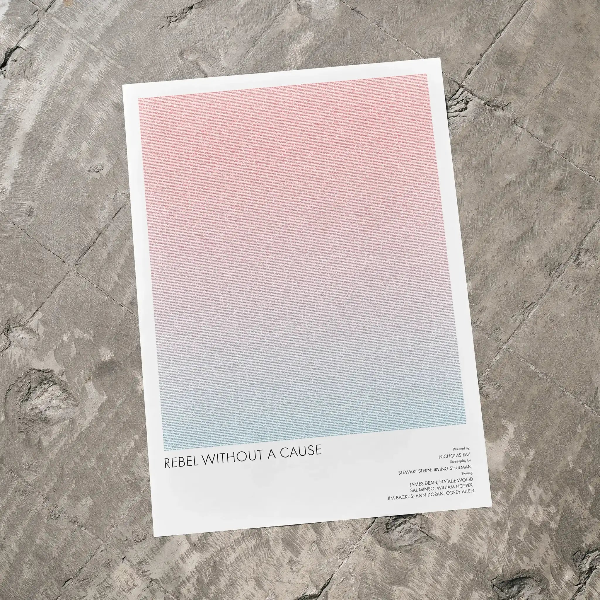 A Rebel Without a Cause movie script poster laid flat on a textured floor surface.