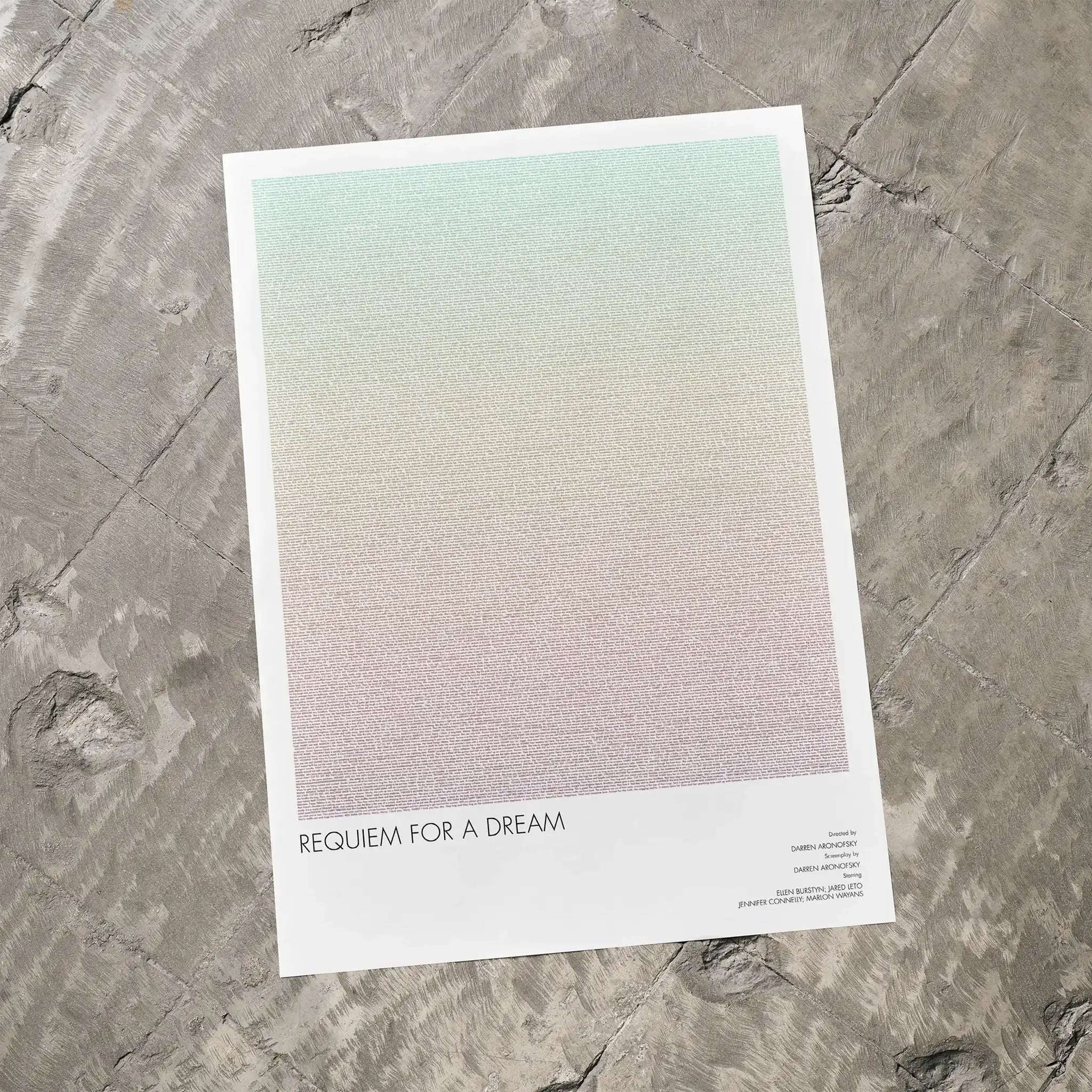 A Requiem for a Dream movie script poster laid flat on a textured floor surface.