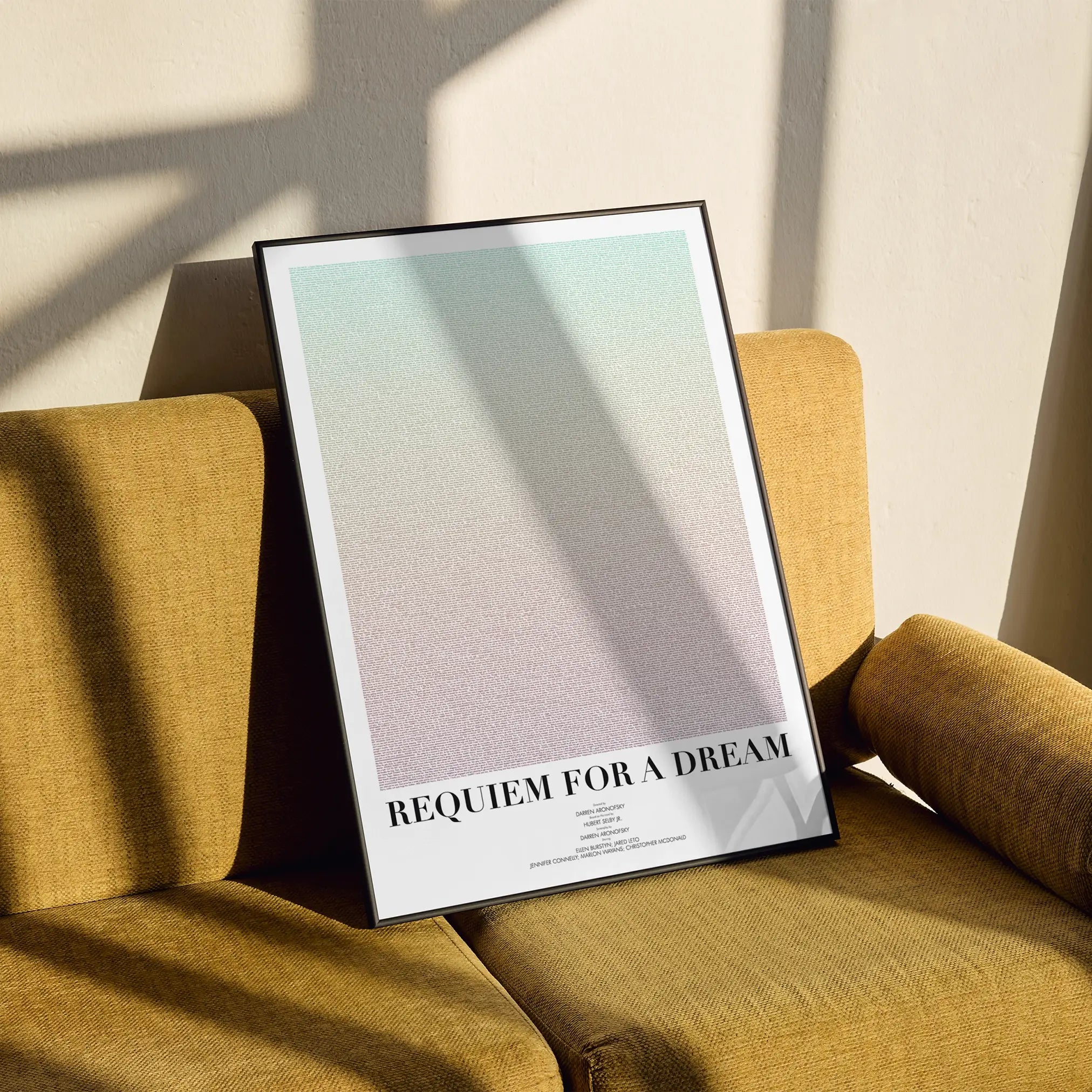 A framed Requiem for a Dream movie script poster styled in a clean interior setting.