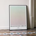 A framed Requiem for a Dream movie script poster leaning against a wall in a minimalist interior.