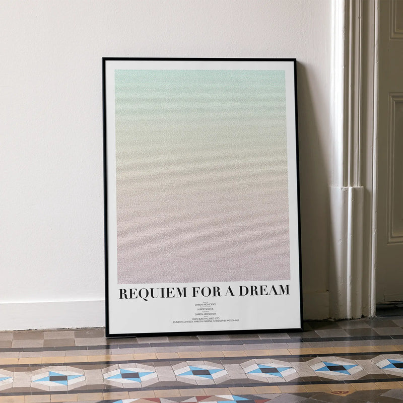 A framed Requiem for a Dream movie script poster leaning against a wall in a minimalist interior.