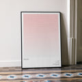 A framed Rocky movie script poster leaning against a wall in a minimalist interior.