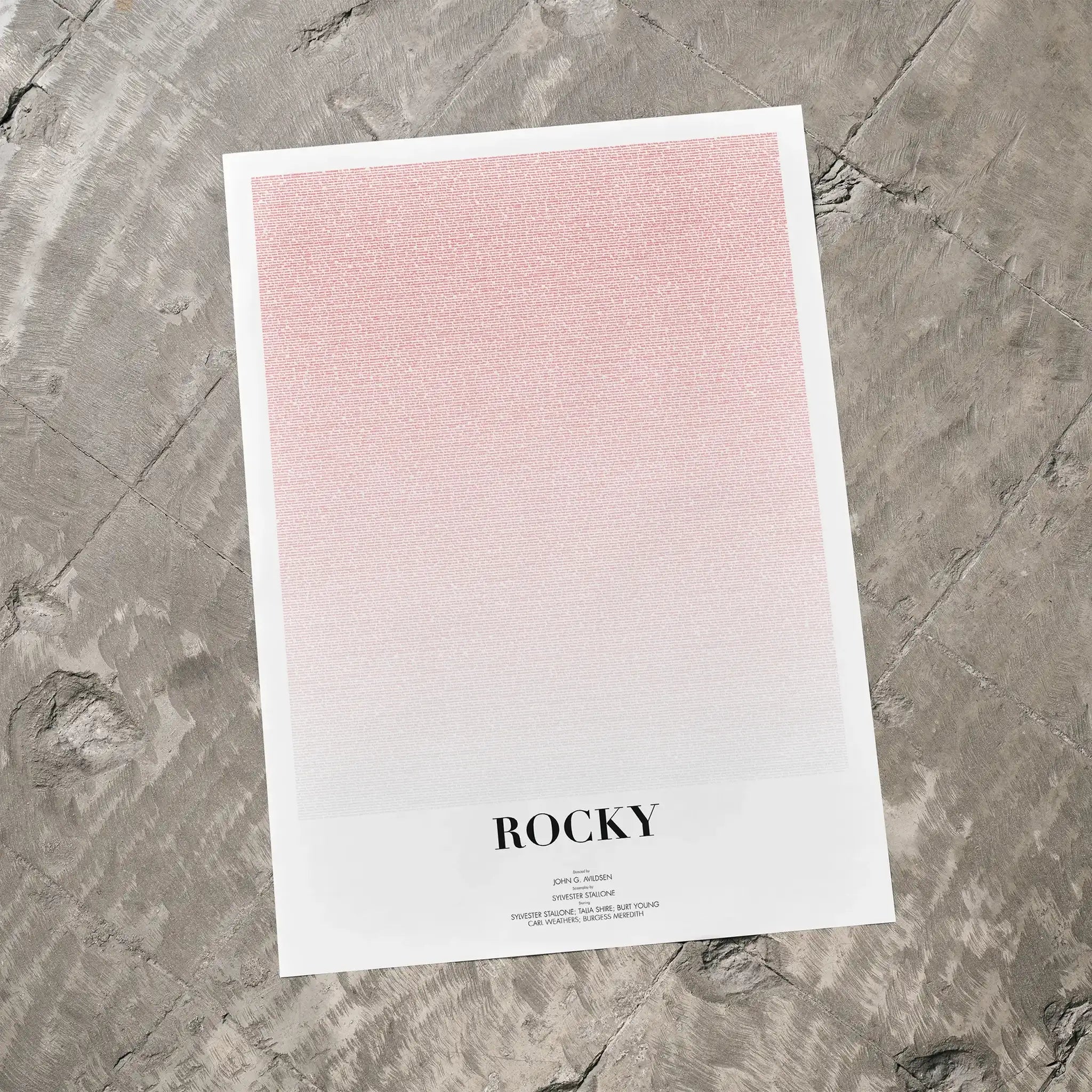 A Rocky movie script poster laid flat on a textured floor surface.