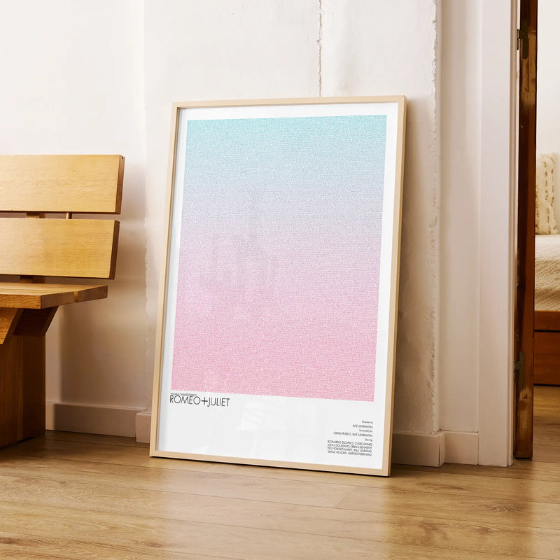 A framed Romeo + Juliet movie script poster arranged in a minimalist interior setting.