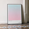 A framed Romeo + Juliet movie script poster leaning against a wall in a minimalist interior.