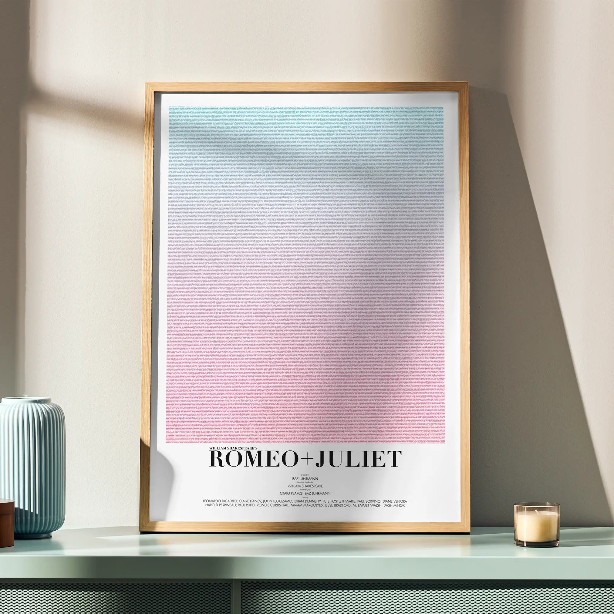 A framed Romeo + Juliet movie script poster displayed in a simple modern interior.
