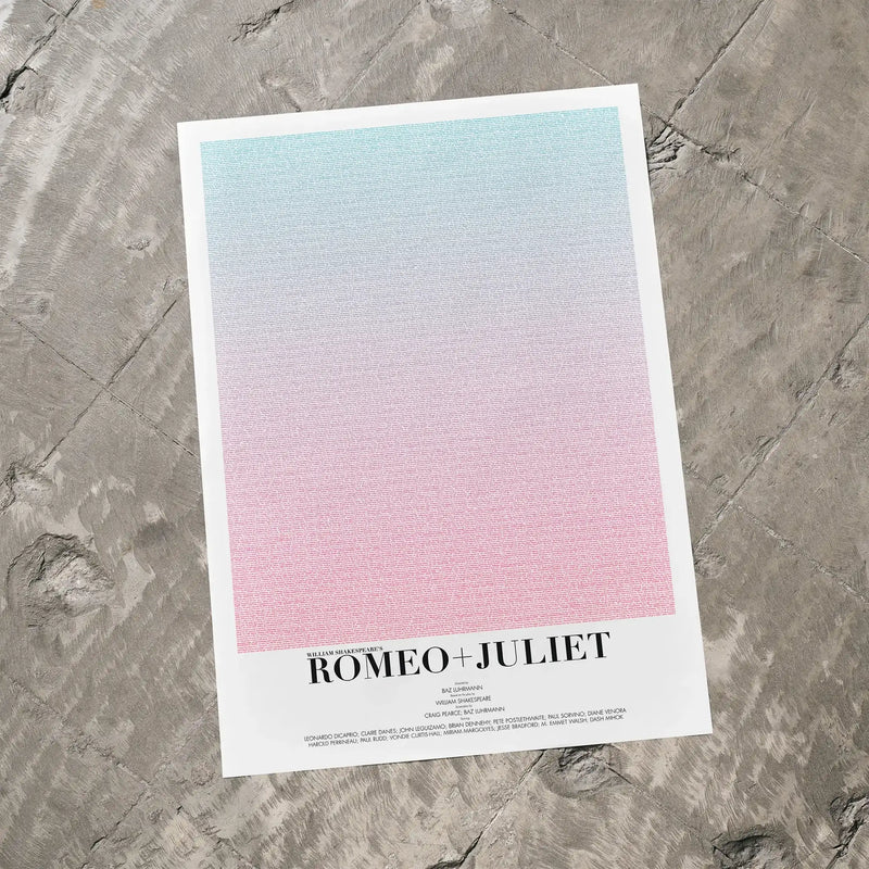 A Romeo + Juliet movie script poster laid flat on a textured floor surface.