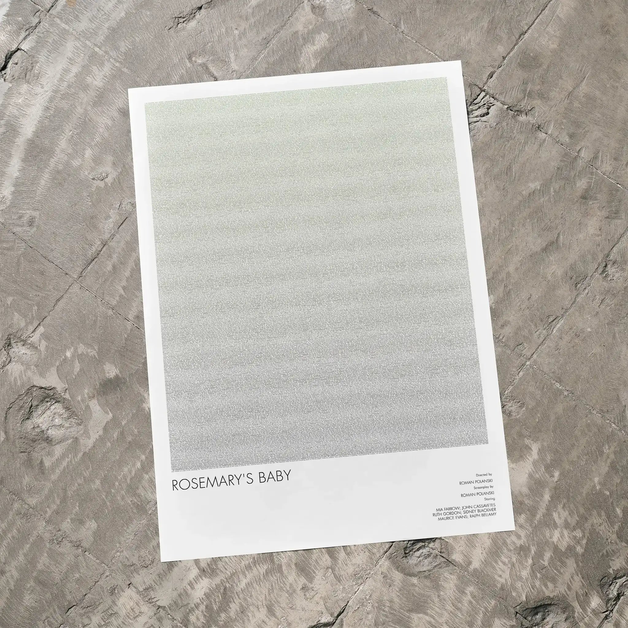 A Rosemary's Baby movie script poster laid flat on a textured floor surface.